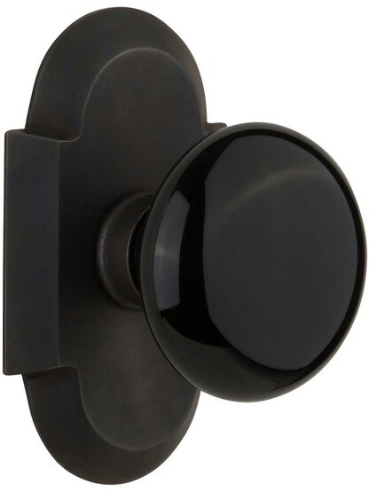Arched Rosette Door Set with Black Porcelain Knobs in Oil-Rubbed Bronze.